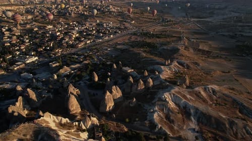 Cappadocia, Turkey, Revealing Drone Shot of Hot Air Balloons Flying Above Fairytale Landscape on Sun