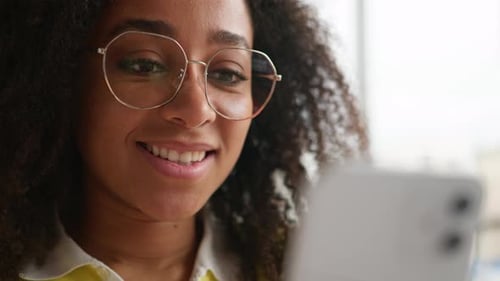 Close Up African American Woman Typing Touchscreen Mobile Phone Indoors Smiling Student Girl Female