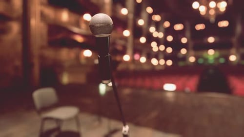 Warm Stage Microphone with Blurred Bokeh Lights
