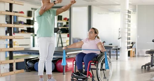 Woman in Wheelchair Doing Resistance Band Exercise