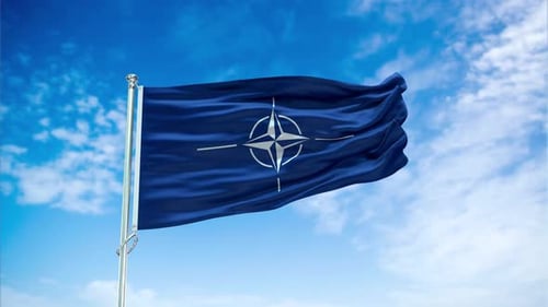 NATO Flag Waving in Blue Sky with Realistic Clouds