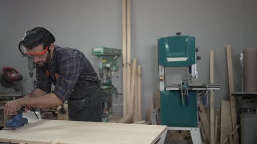 Carpenter is working at workshop.