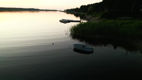 A Serene Aerial View Captures Boats on a Calm Lake at Sunset Creating a Tranquil and Peaceful