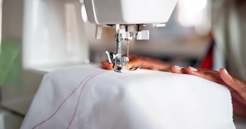 Tailor, sewing and hands with fabric in machine for creative production of clothes or fashion