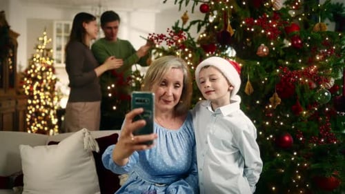 Grandmother and Grandchild Taking Christmas Selfie at Home