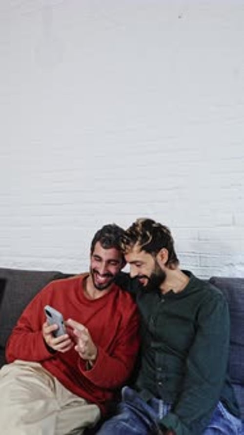 Gay Couple Sharing a Moment of Joy on Smartphone