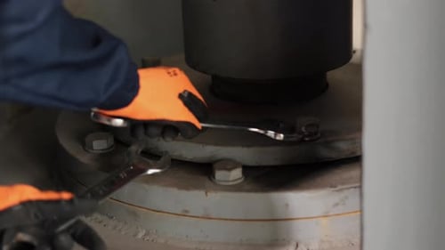 Tightening Bolts on Industrial Machine with Wrenches