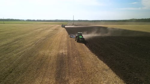 Tractors plowing the field in Ukraine