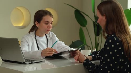 Doctor Discussing Patient Chart in Clinic Office