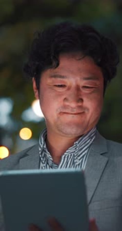 Business, night and Asian man on tablet in city for communication, typing email and networking