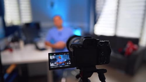 Close look at the display of a digital camera recording a man in blue uniform.