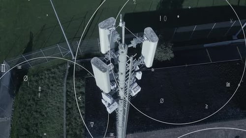 Aerial View of a Telecommunications Tower Surrounded By Signal Waves and Technology