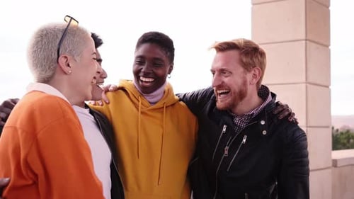 Multiracial and Diverse Group of Friends Hugging in Circle and Looking Down at the Camera