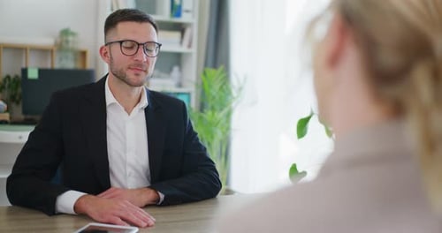 Smiling Real Estate Agent Shakes Hands During Negotiations