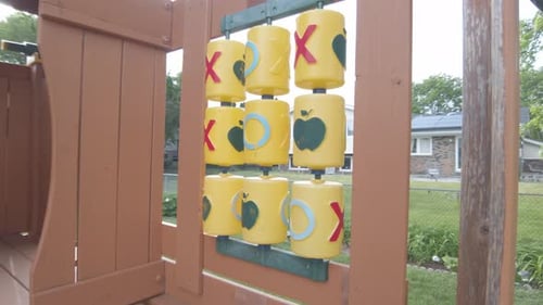 Colorful tic tac toe on end of kids tree house.