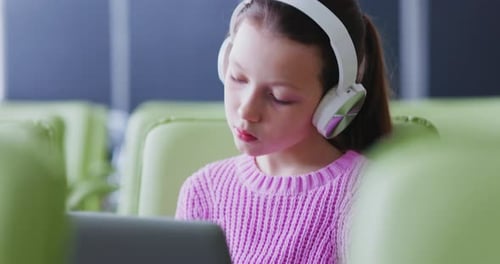Girl Wearing Headphones Using a Tablet