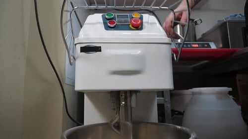 A Closeup of the Chef Turns on a Food Processor for Kneading Burger Dough