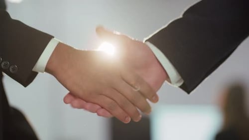 Cropped View of a Strong Handshake Two Businessmen Shake Hands After Signing a Contract Business