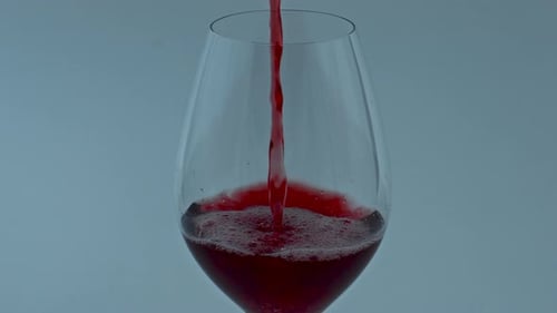 Red wine being poured into a wine glass
