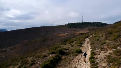 Aerial crane shot of traveler with backpack walking on trek, Way of St, James, Spain