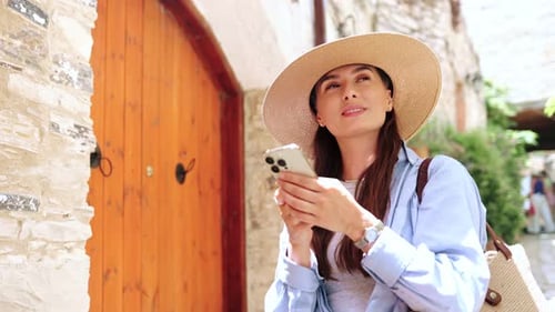 Woman Sightseeing Using Smartphone in European Town