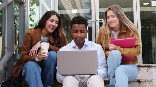Students Laughing Together Over a Laptop Computer