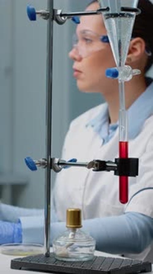 Scientist Works in Lab with Scientific Equipment