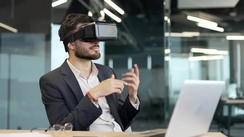 Man in VR Headset Gesturing in Digital Workspace