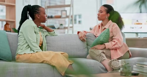 Women Friends Chatting on Sofa in Living Room