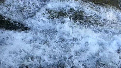 Strong Turbulent Stream of a Waterfall Flowing at High Speed Closeup Rushing Water