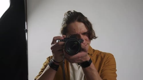 Model and Production Team in the Studio Man Professional Photographer Taking Picture Looking