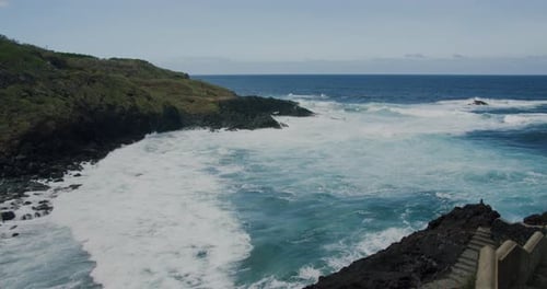 Rough sea water and rocky coastline. Atalantic ocean waves and water crash on the rocks along the co