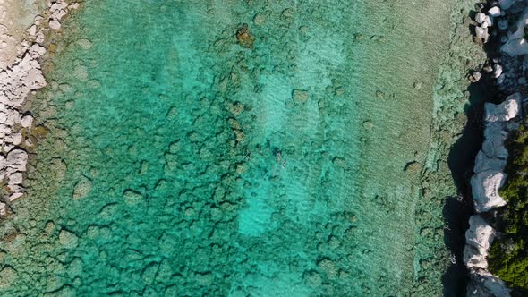 Aerial riser above divers in idyllic clear blue ocean of Pefkos, Rhodes ...