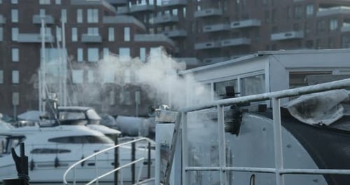 Boat Emitting White Smoke In A Harbour