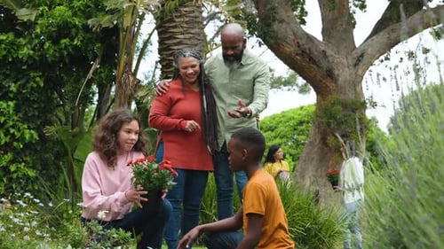 Family Gardening Together in Lush Backyard Garden