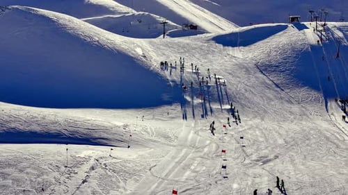 Aerial View of Skiers Training on a Snowy Mountain Slope