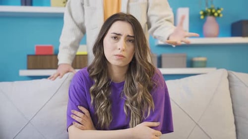 Sad Woman Listening to Man's Angry Argument