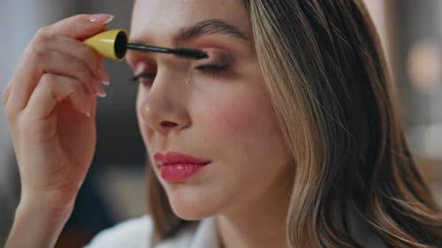Woman Applying Mascara for Beauty and Self-Care