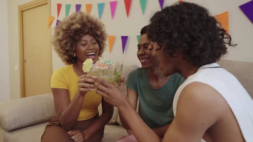 Four LGBTQIA Friends Enjoying Mojitos and Laughing at a House Gathering
