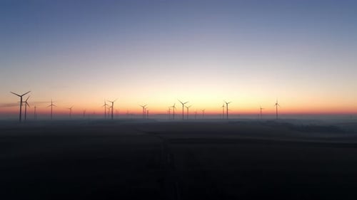 Wind Farm Generating Wind Power At Sunrise - Drone Shot