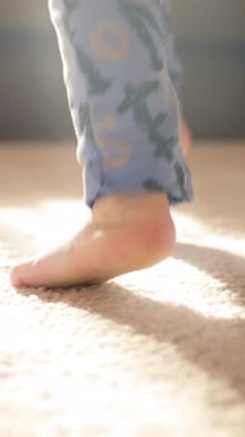 Vertical of Blurry Photo of a Person Walking on a Carpet