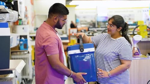 Indian Couple Buying Portable Refrigerator for Travel in Appliances Store
