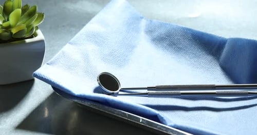 Shiny Dental Tools on Blue Cloth Preparation