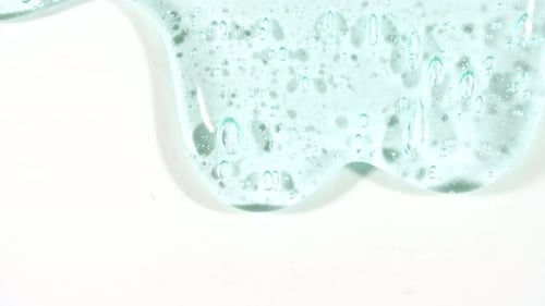 Cosmetic Gel Fluid With Molecule Bubbles Flowing On The Plain White Background Liquid Cream Gel