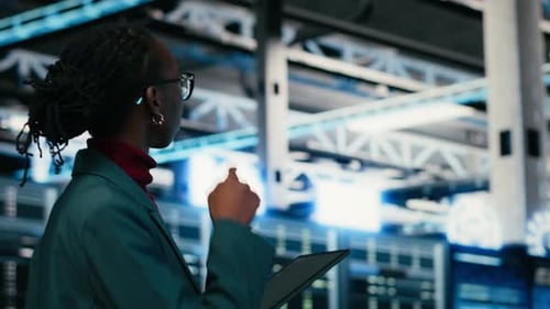 Data Center Programmer Writing Code for Resource Optimization Using Tablet