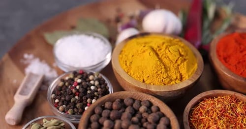 Aromatic spices and herbs arranged in wooden bowls
