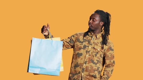 Cheerful Person Holding Shopping Paper Bags in Studio