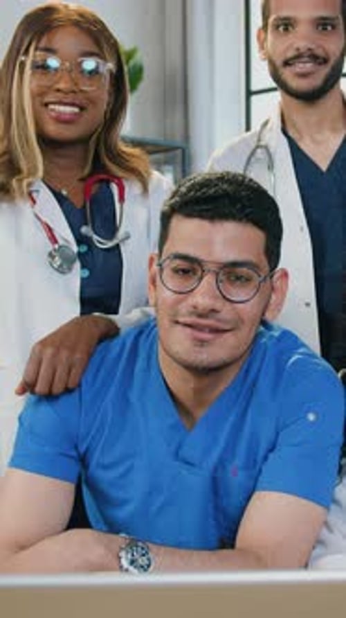Smiling Medical Professionals in Scrubs and White Coats