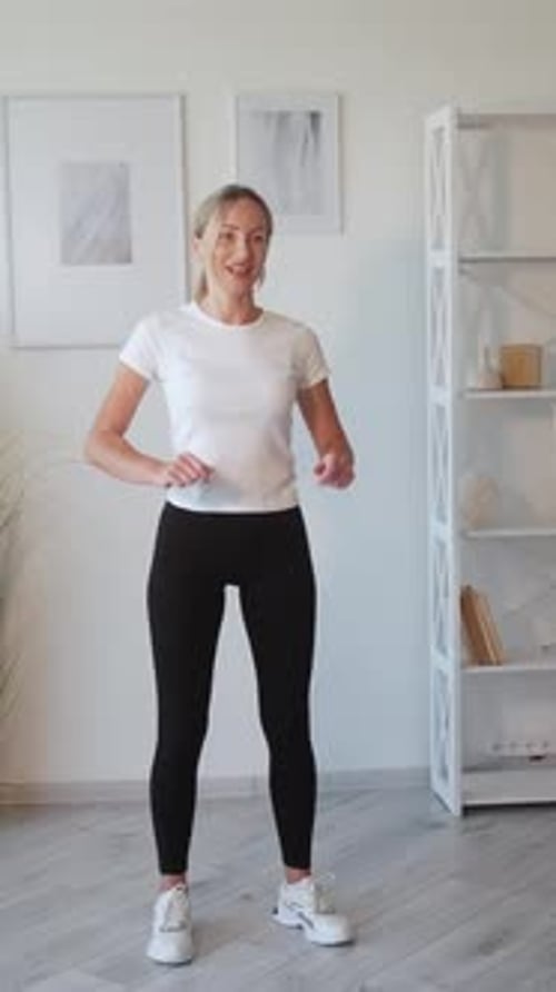 Woman Exercising at Home in Black Leggings