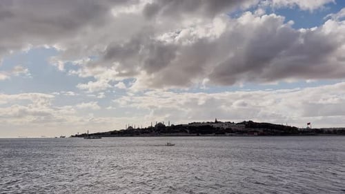 Ferries, boats, sailboats, birds, breakwater, pier, waves in the sea in cloudy weather in autumn